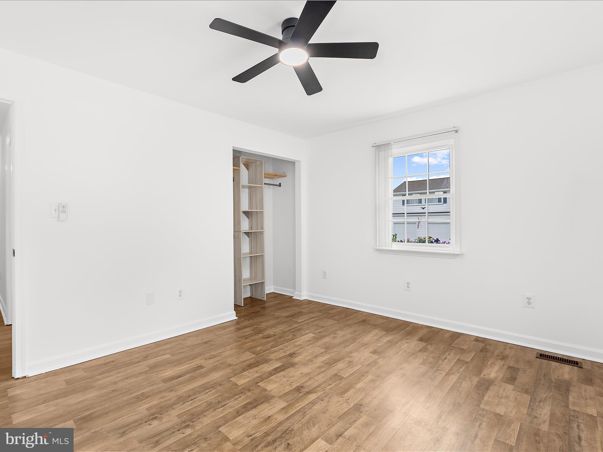 8475 Sexton Road Pasadena, MD 21122 - Photo 38 of 58 an empty room with a window and a ceiling fan