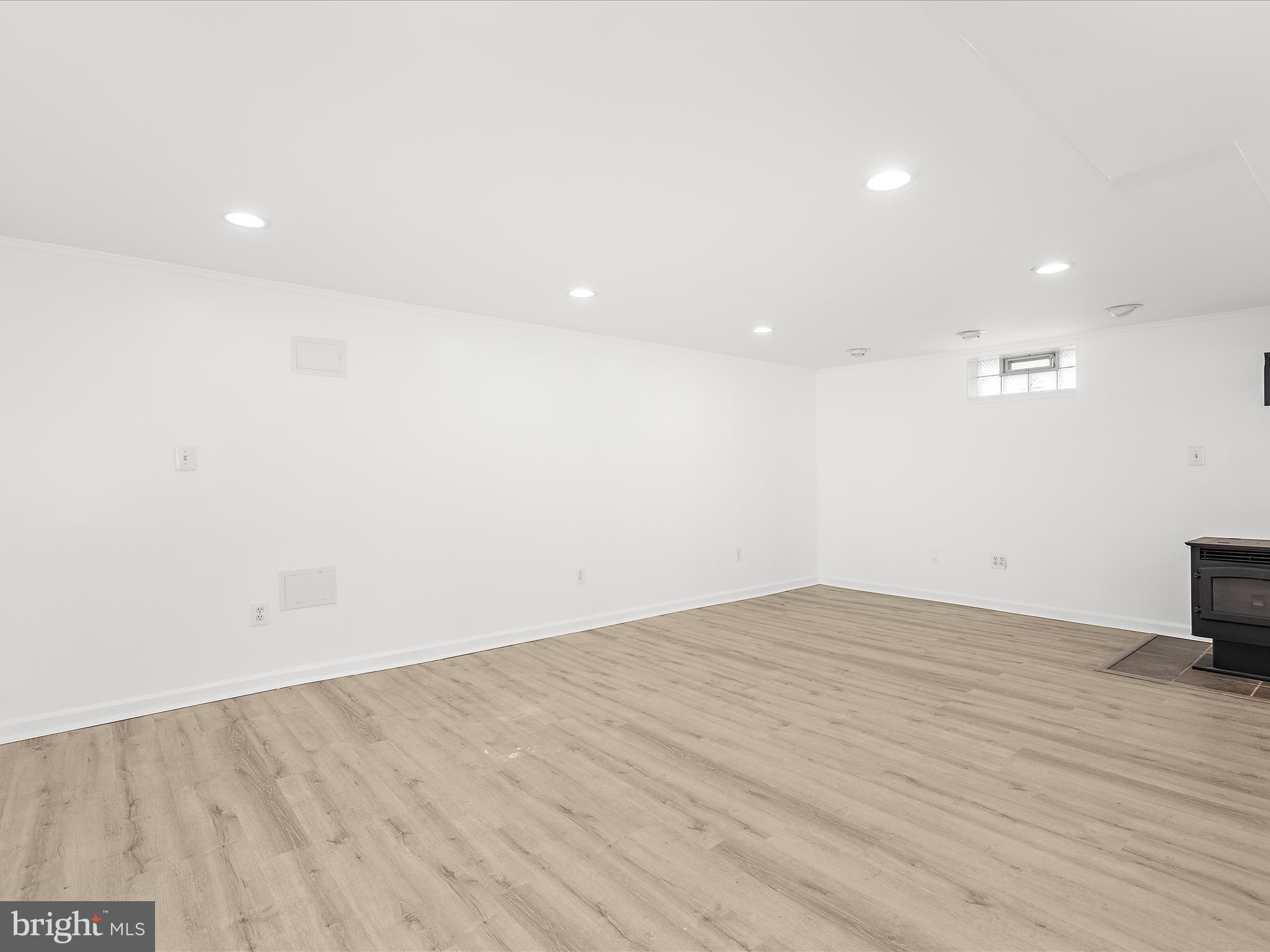 8475 Sexton Road Pasadena, MD 21122 - Photo 39 of 58 an empty room with wooden floor and a ceiling fan