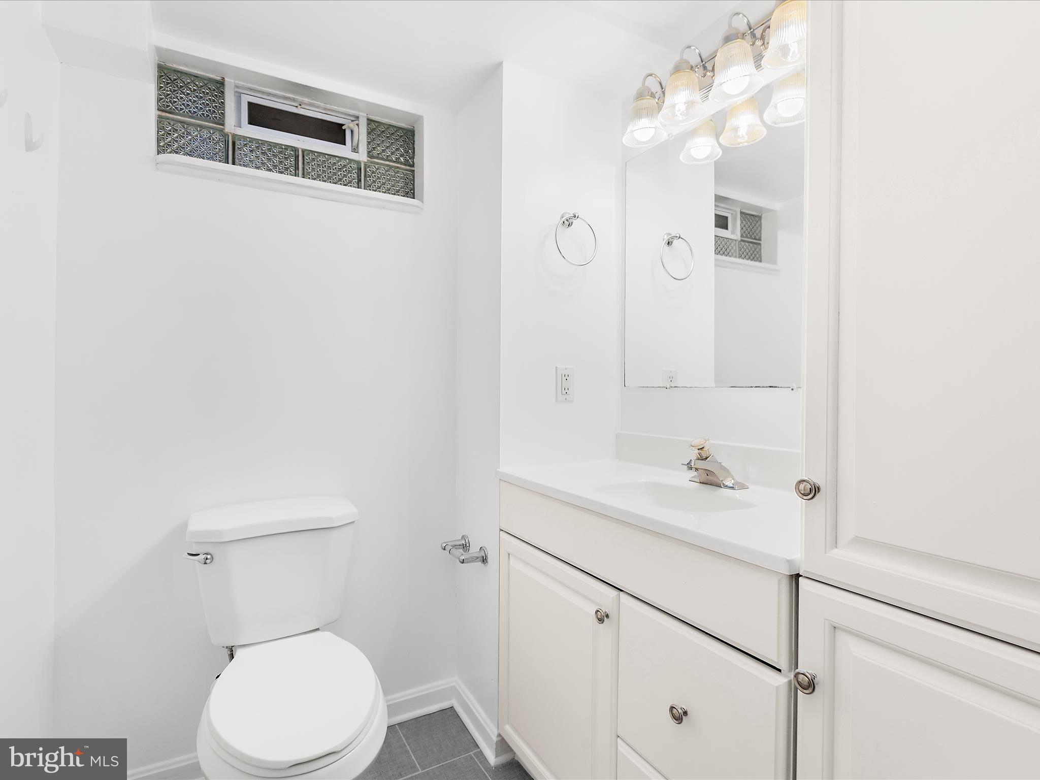 8475 Sexton Road Pasadena, MD 21122 - Photo 48 of 58 a bathroom with a sink a toilet and vanity