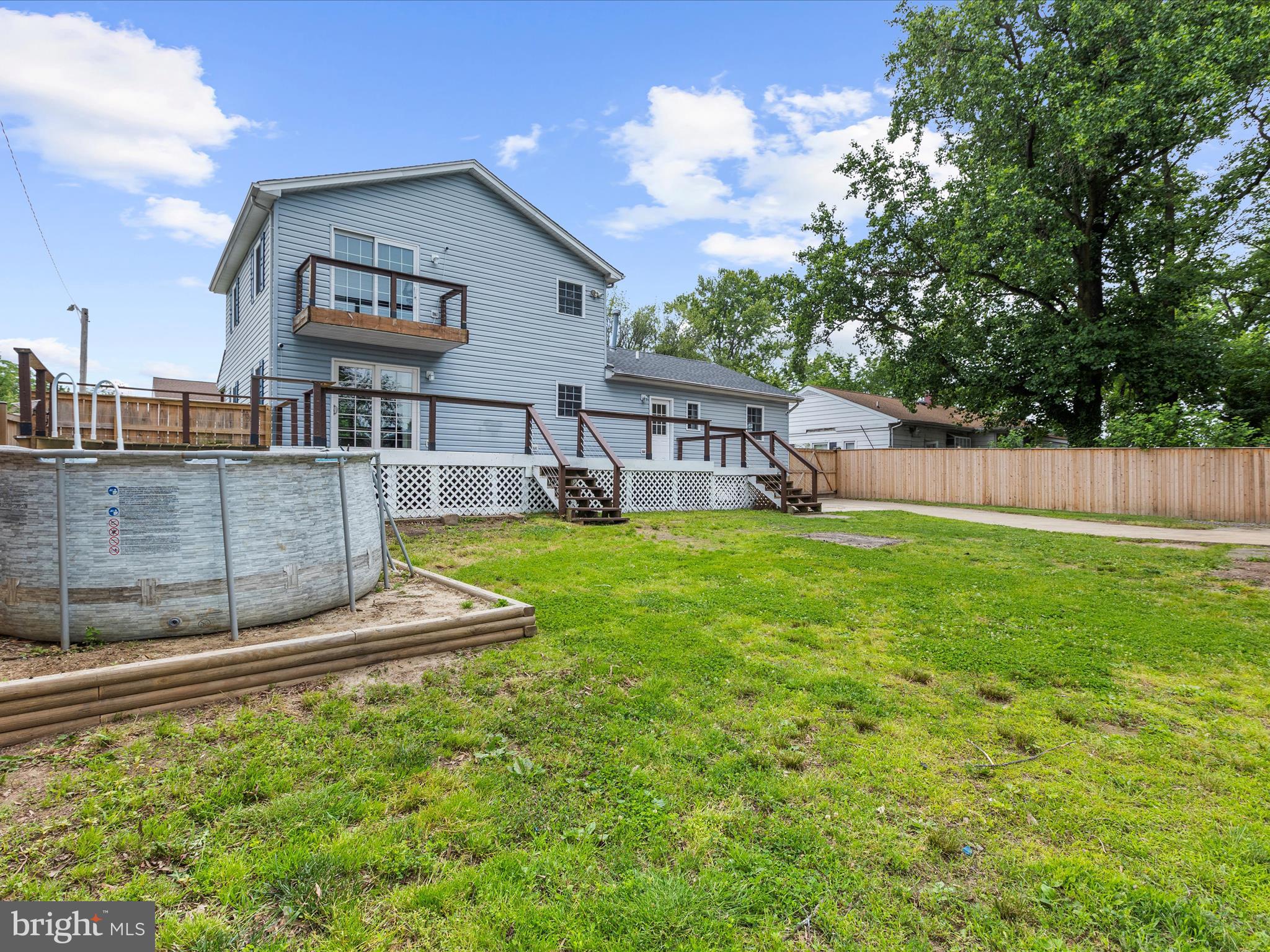 8475 Sexton Road Pasadena, MD 21122 - Photo 55 of 58 a view of a house with a yard and sitting area