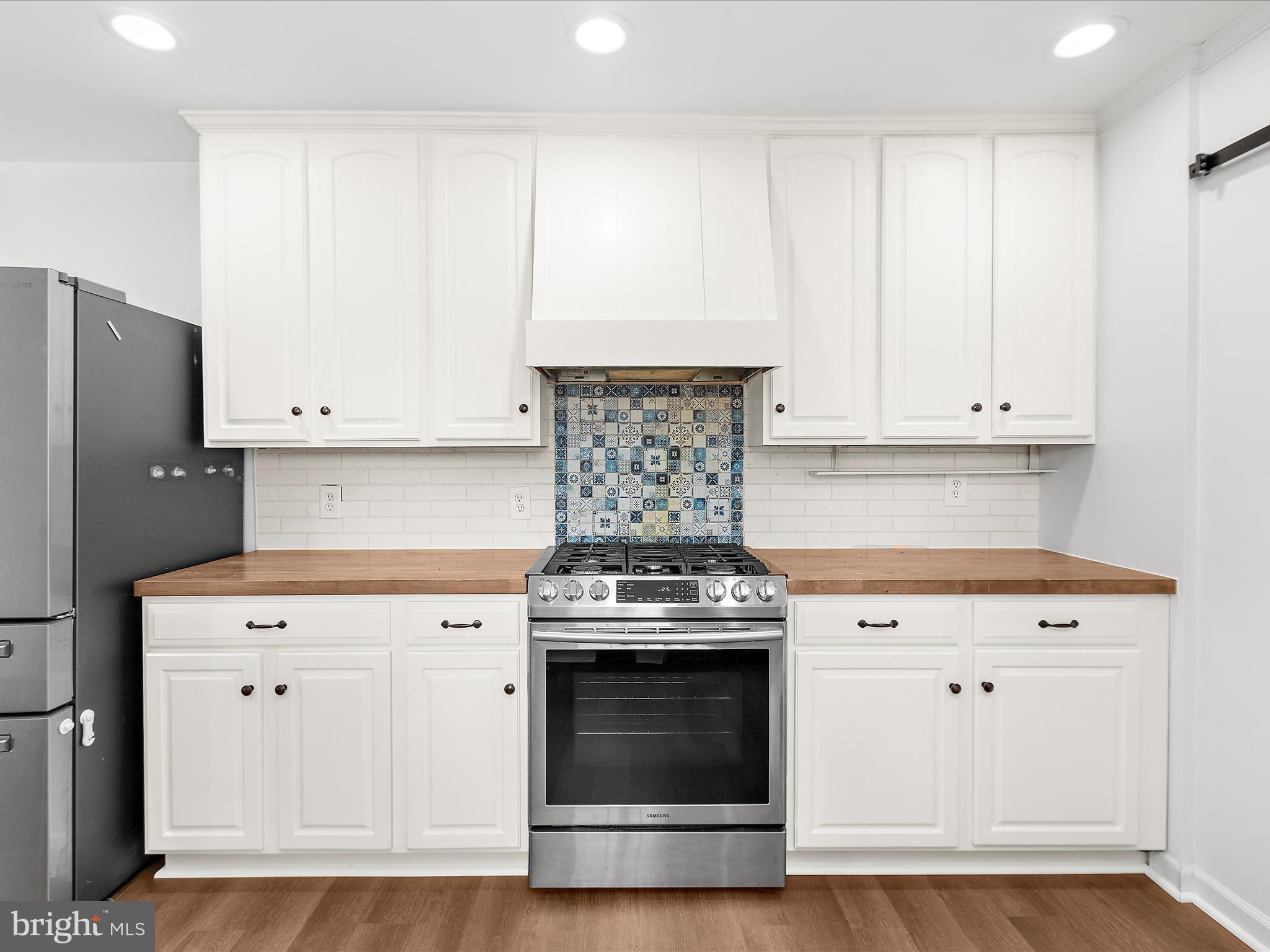 8475 Sexton Road Pasadena, MD 21122 - Photo 7 of 58 a kitchen with granite countertop white cabinets and stainless steel appliances