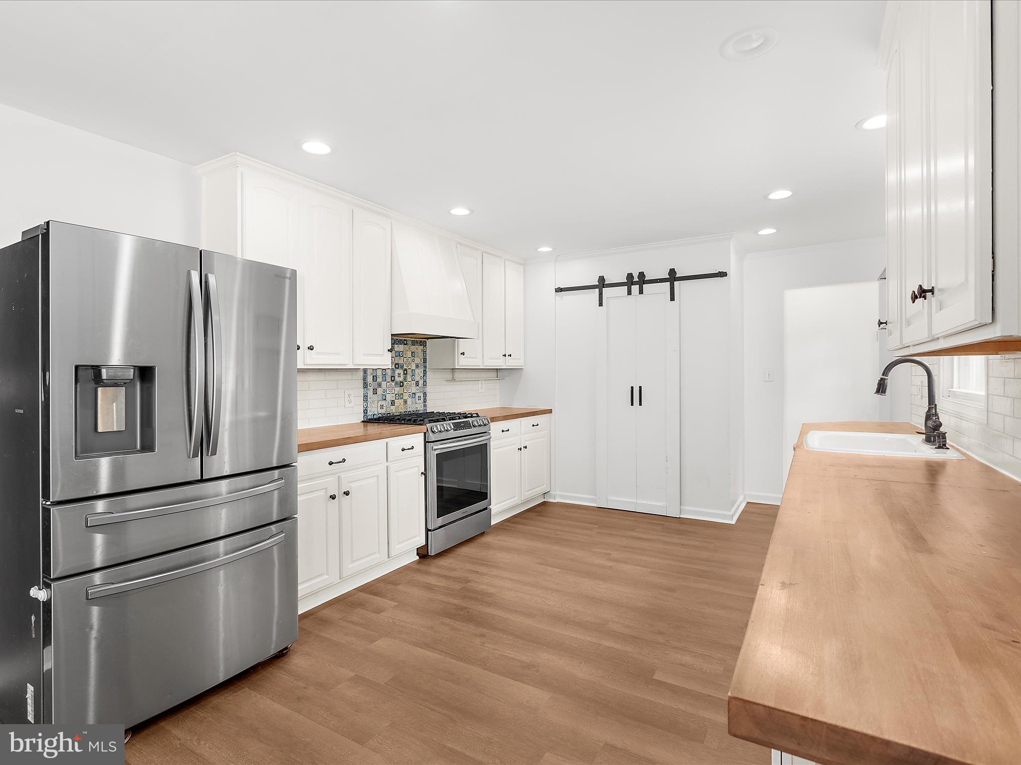 8475 Sexton Road Pasadena, MD 21122 - Photo 9 of 58 a kitchen with stainless steel appliances a refrigerator sink and microwave