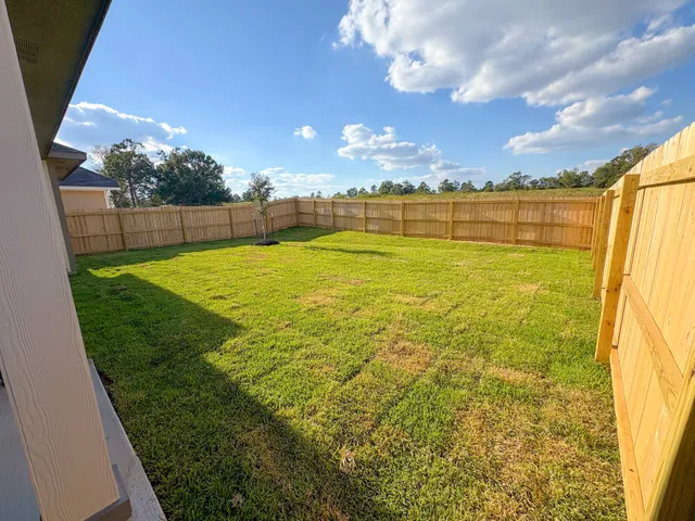 a view of a house with a backyard