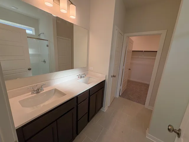 a bathroom with a double vanity sink a and mirror