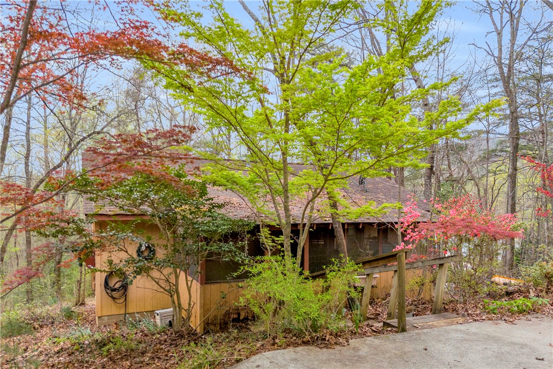 115 Little Stakey Rd Mountain Rest Mountain Rest, SC 29664 - Photo 1 of 38 Escape to this private sanctuary nestled among vibrant trees, offering a serene woodland retreat.