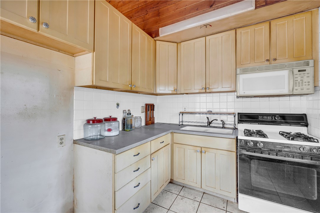 115 Little Stakey Rd Mountain Rest Mountain Rest, SC 29664 - Photo 13 of 38 This kitchen offers functional design with essential appliances and ample storage.