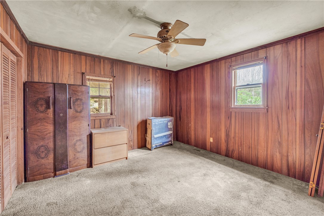 115 Little Stakey Rd Mountain Rest Mountain Rest, SC 29664 - Photo 14 of 38 This cozy room features warm wood paneling, a ceiling fan, and ample natural light through its windows.