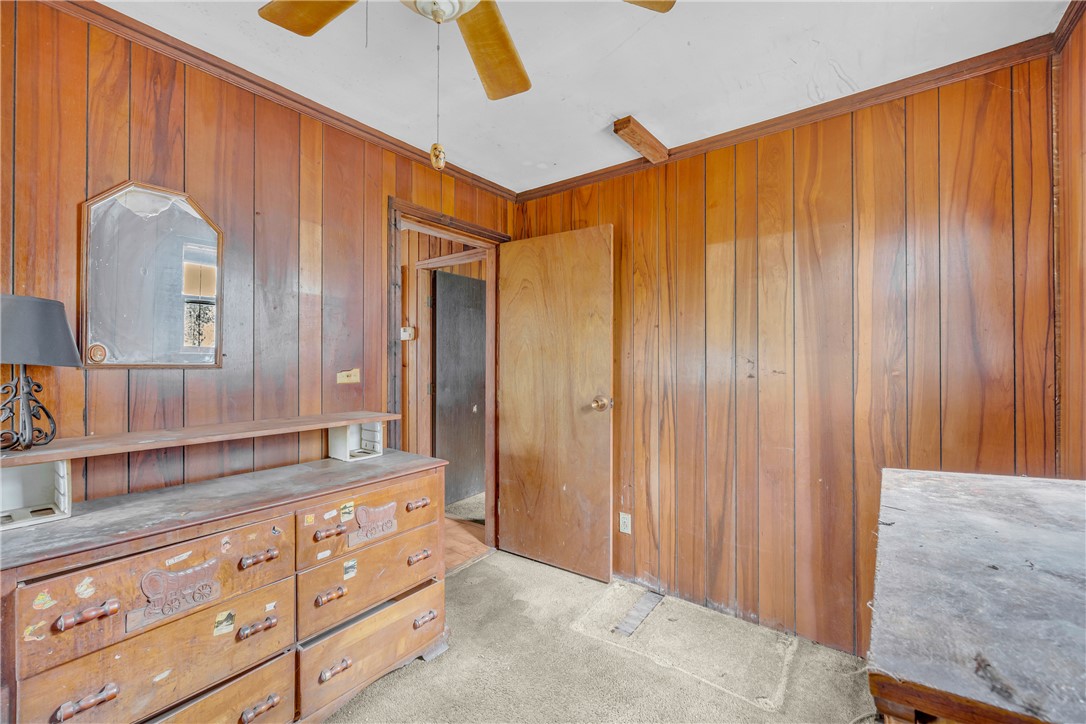115 Little Stakey Rd Mountain Rest Mountain Rest, SC 29664 - Photo 17 of 38 This cozy bedroom features warm wood paneling, offering a rustic and inviting atmosphere.