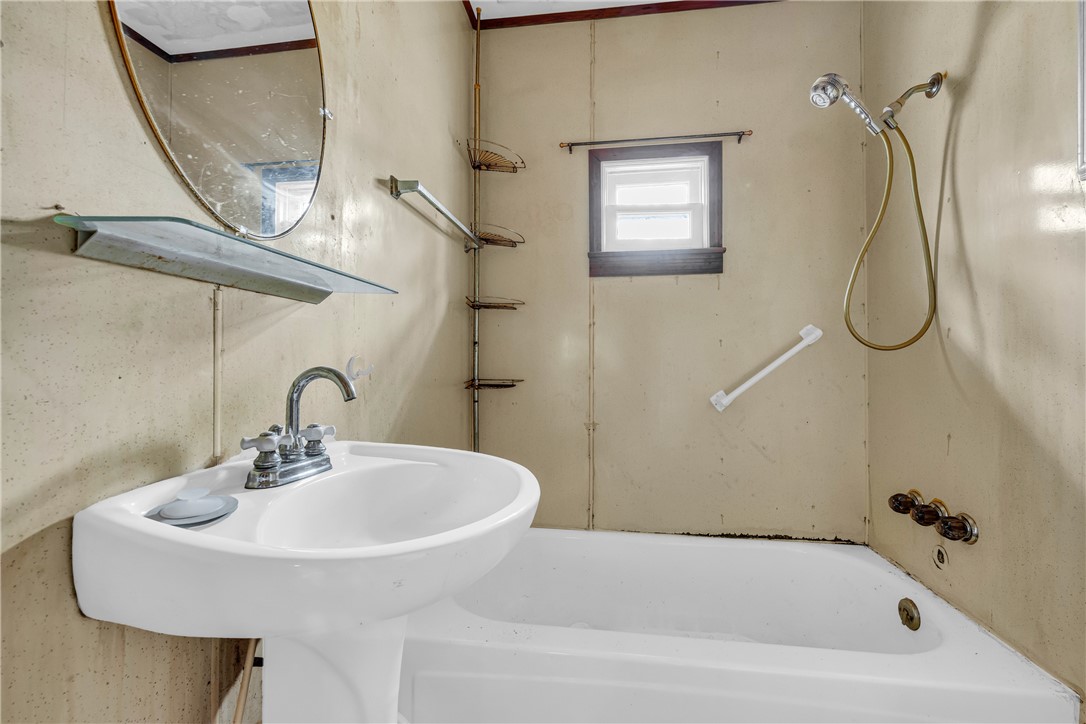 115 Little Stakey Rd Mountain Rest Mountain Rest, SC 29664 - Photo 19 of 38 This functional bathroom features a classic pedestal sink and practical bathtub with a shower attachment.