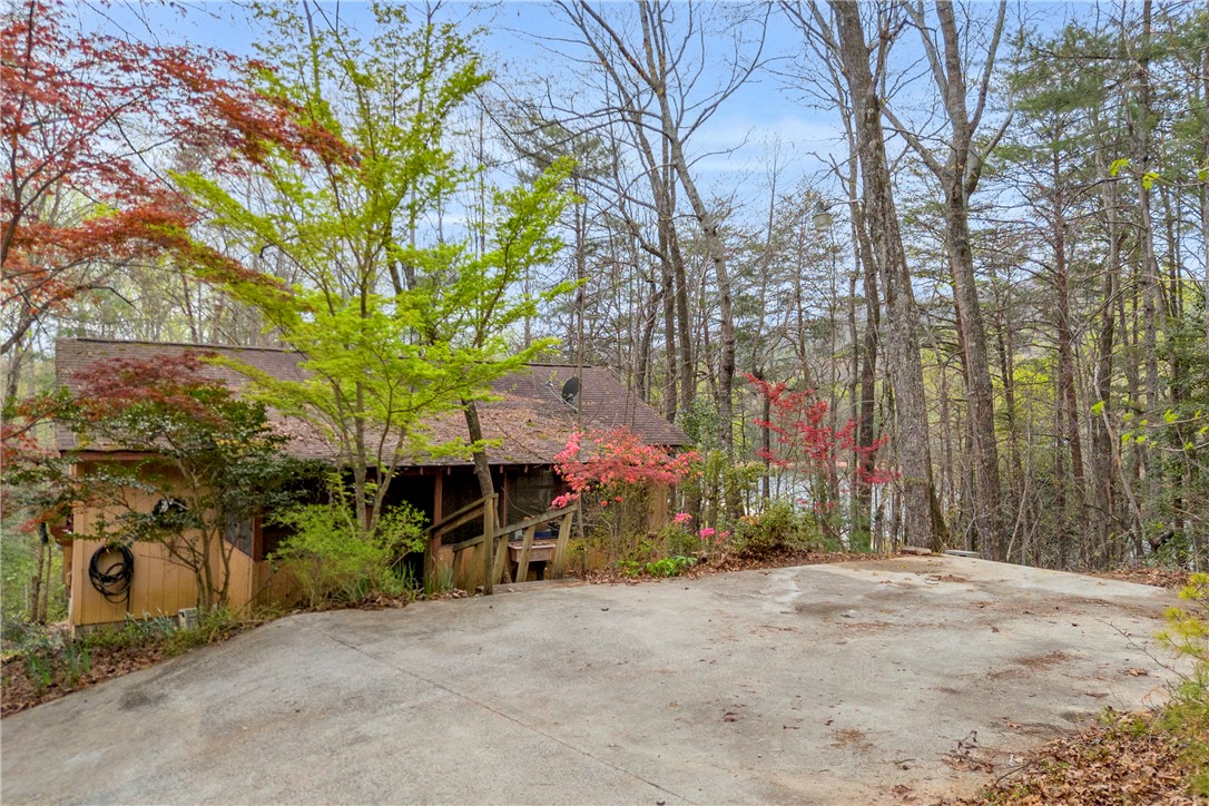 115 Little Stakey Rd Mountain Rest Mountain Rest, SC 29664 - Photo 20 of 38 This charming retreat, nestled amongst lush trees, offers a private setting and a tranquil view.
