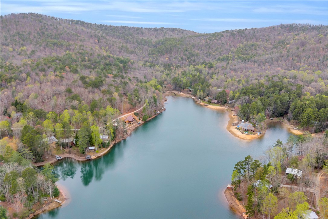 115 Little Stakey Rd Mountain Rest Mountain Rest, SC 29664 - Photo 34 of 38 This aerial view showcases a tranquil waterfront property nestled among lush hills.