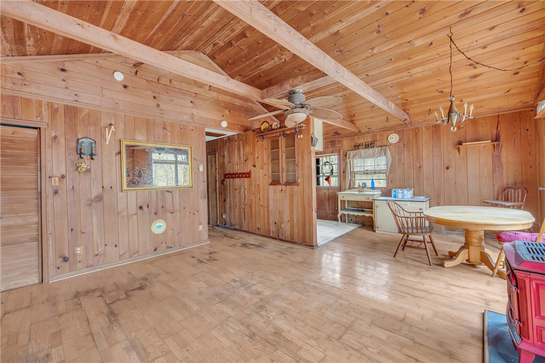 115 Little Stakey Rd Mountain Rest Mountain Rest, SC 29664 - Photo 6 of 38 This inviting interior features natural wood paneling and exposed beam ceilings, creating a rustic and cozy ambiance.