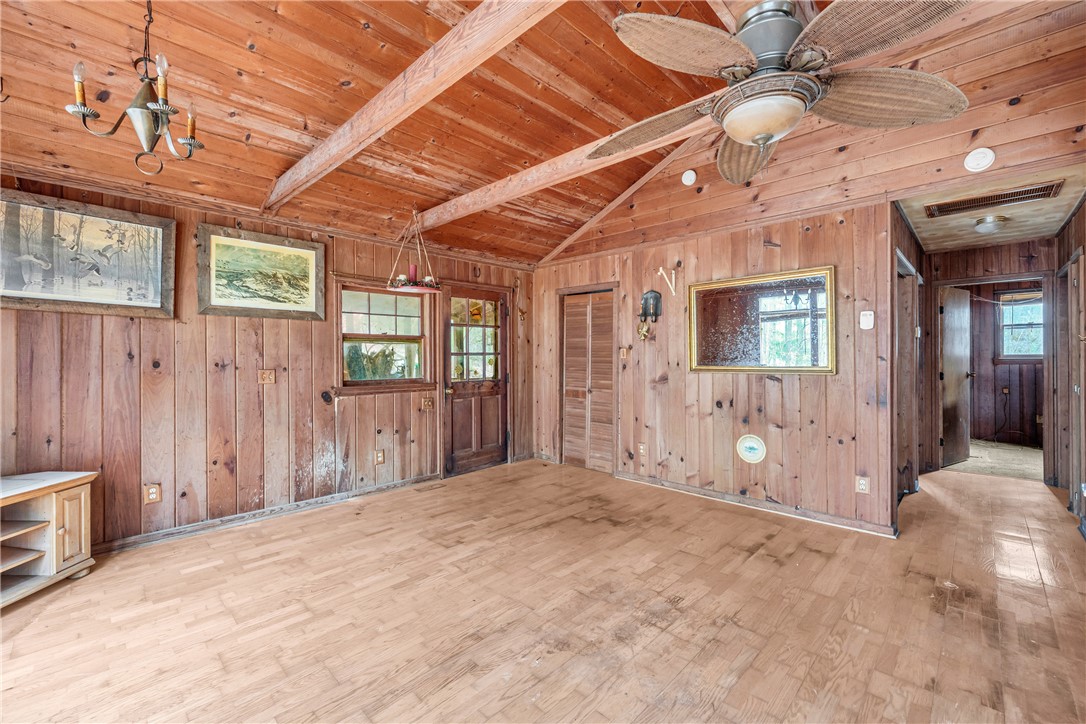 115 Little Stakey Rd Mountain Rest Mountain Rest, SC 29664 - Photo 7 of 38 This inviting space features natural wood paneling and exposed beams, creating a warm, rustic ambiance perfect for any home.