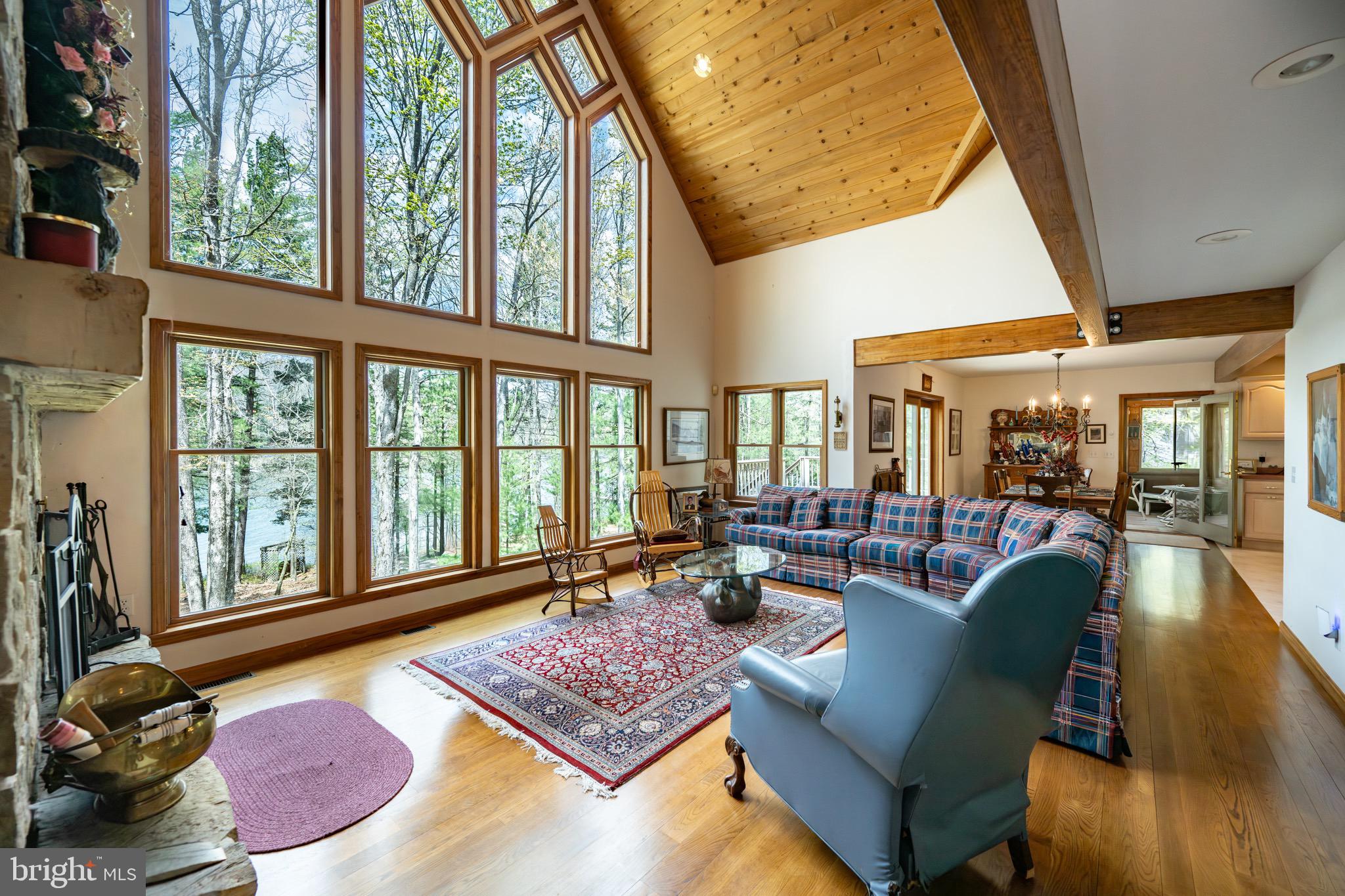 389 Sawmill Hollow Road Swanton, MD 21561 - Photo 5 of 62 a living room with furniture and a floor to ceiling window