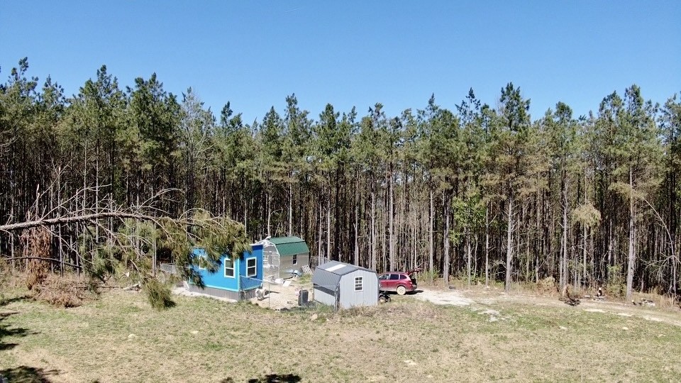 146 Howard Way Hohenwald, TN 38462 - Photo 6 of 14 a view of outdoor space with wooden play ground and trees