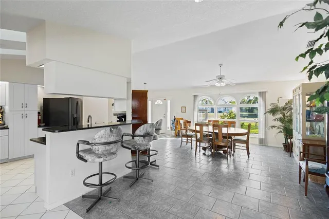a kitchen with white cabinets a sink and white appliances