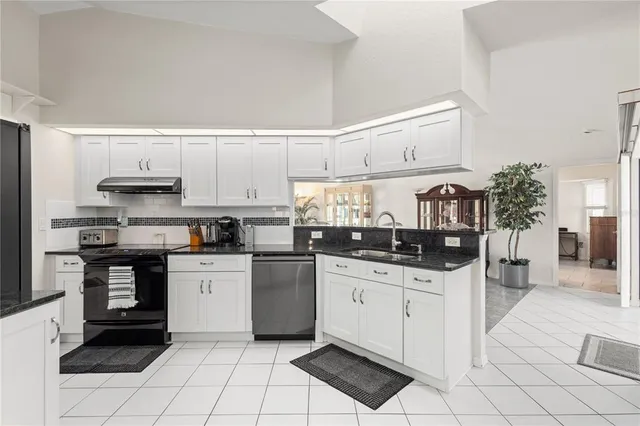 a kitchen with cabinets and chairs
