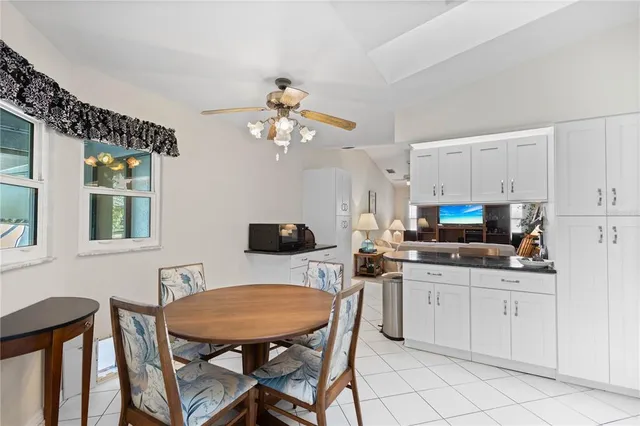 a kitchen with appliances cabinets and chair