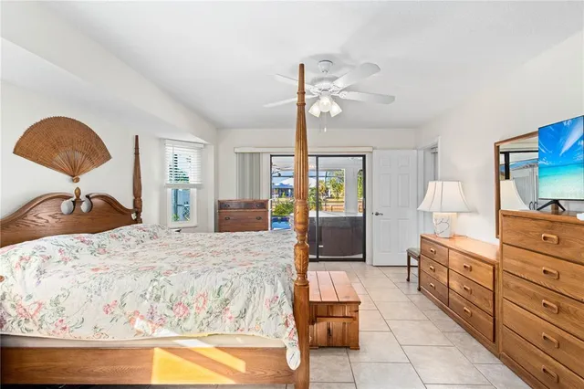 a bedroom with a bed and large windows