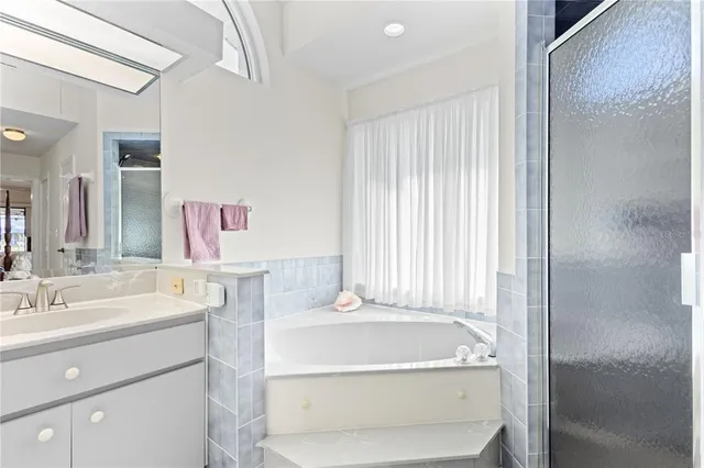 a view of a workspace with bookshelf and a window