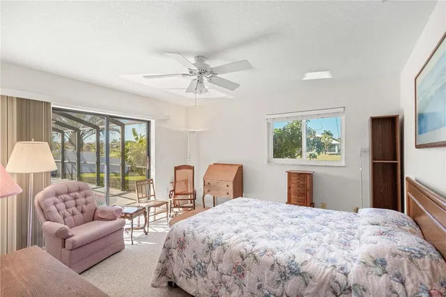 a bedroom with furniture and a ceiling fan