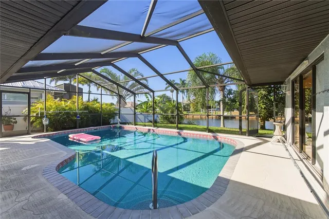 a view of a backyard with table and chairs under an umbrella