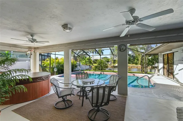 a room with wooden floor table and chairs