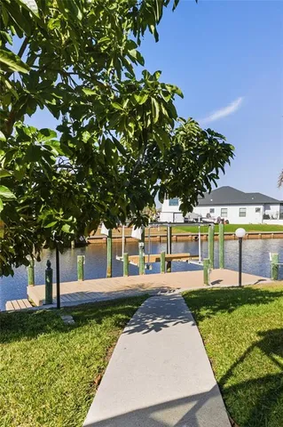 a swimming pool with outdoor seating and yard