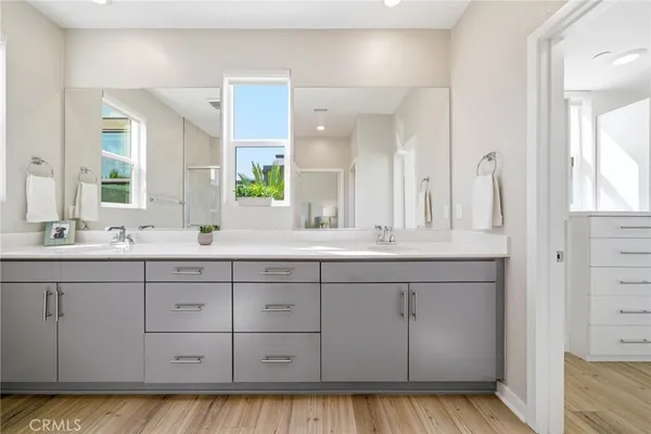 a large bathroom with a granite countertop sink a large mirror a bathtub and window