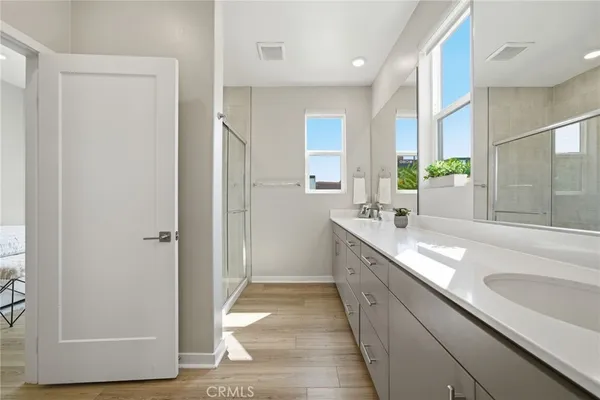 a bathroom with a shower and a glass door