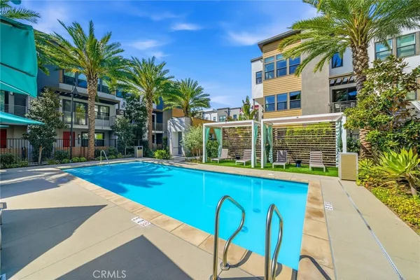 a view of swimming pool with outdoor seating and plants