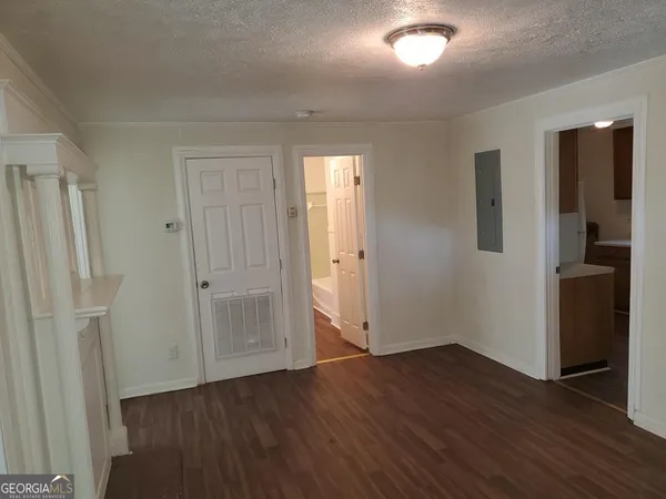 an empty room with wooden floor and a window