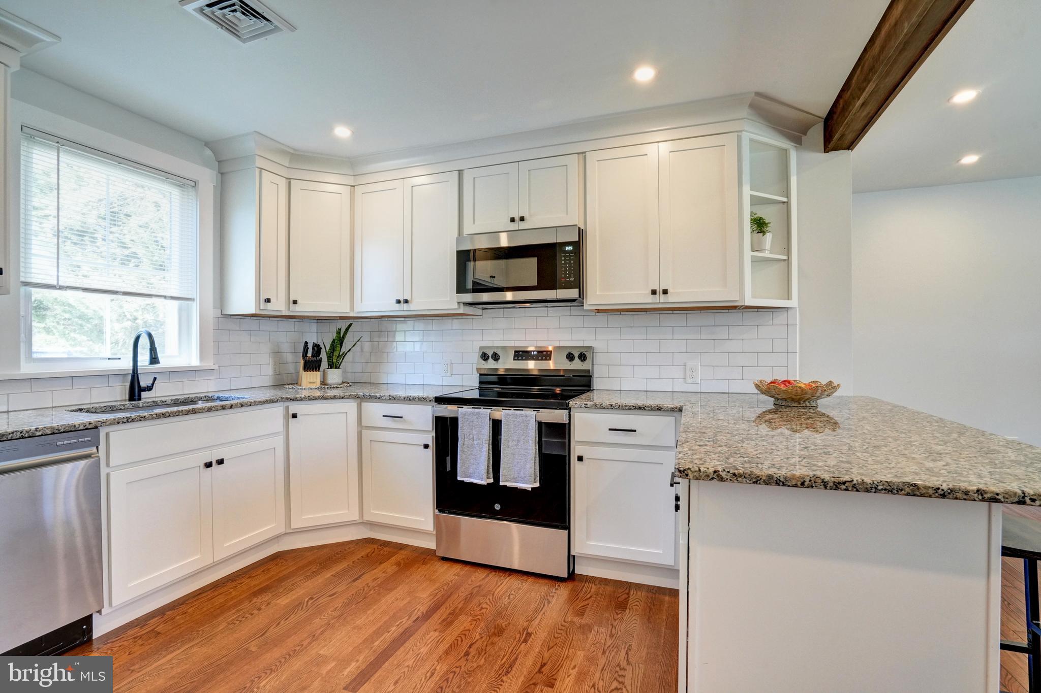 1312 Ship Road West Chester, PA 19380 - Photo 13 of 50 a kitchen with granite countertop white cabinets appliances a sink and a window