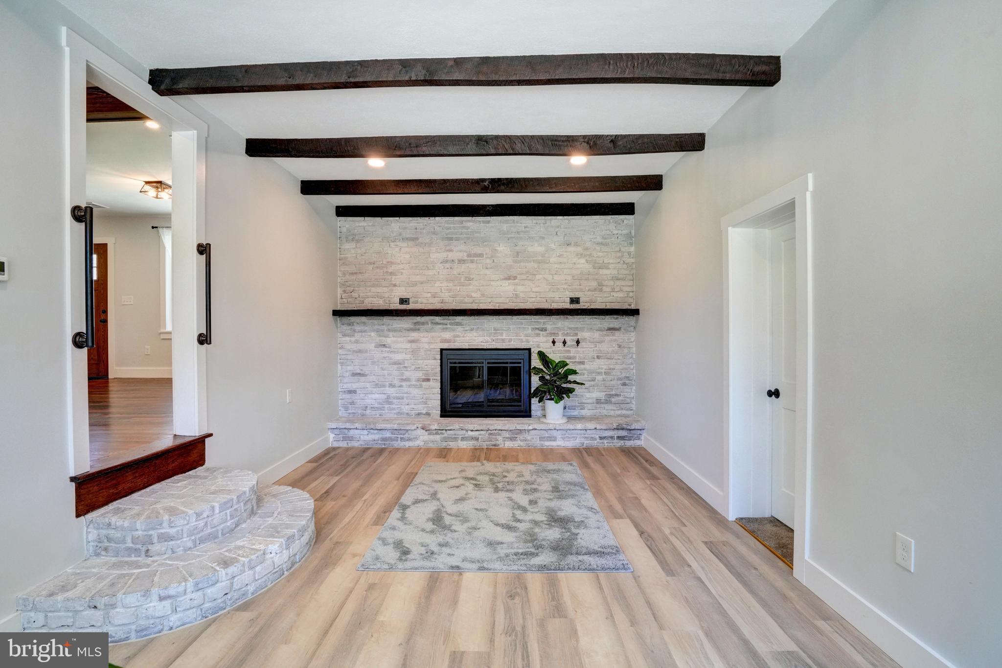 1312 Ship Road West Chester, PA 19380 - Photo 21 of 50 a view of a livingroom with wooden floor a fireplace and window