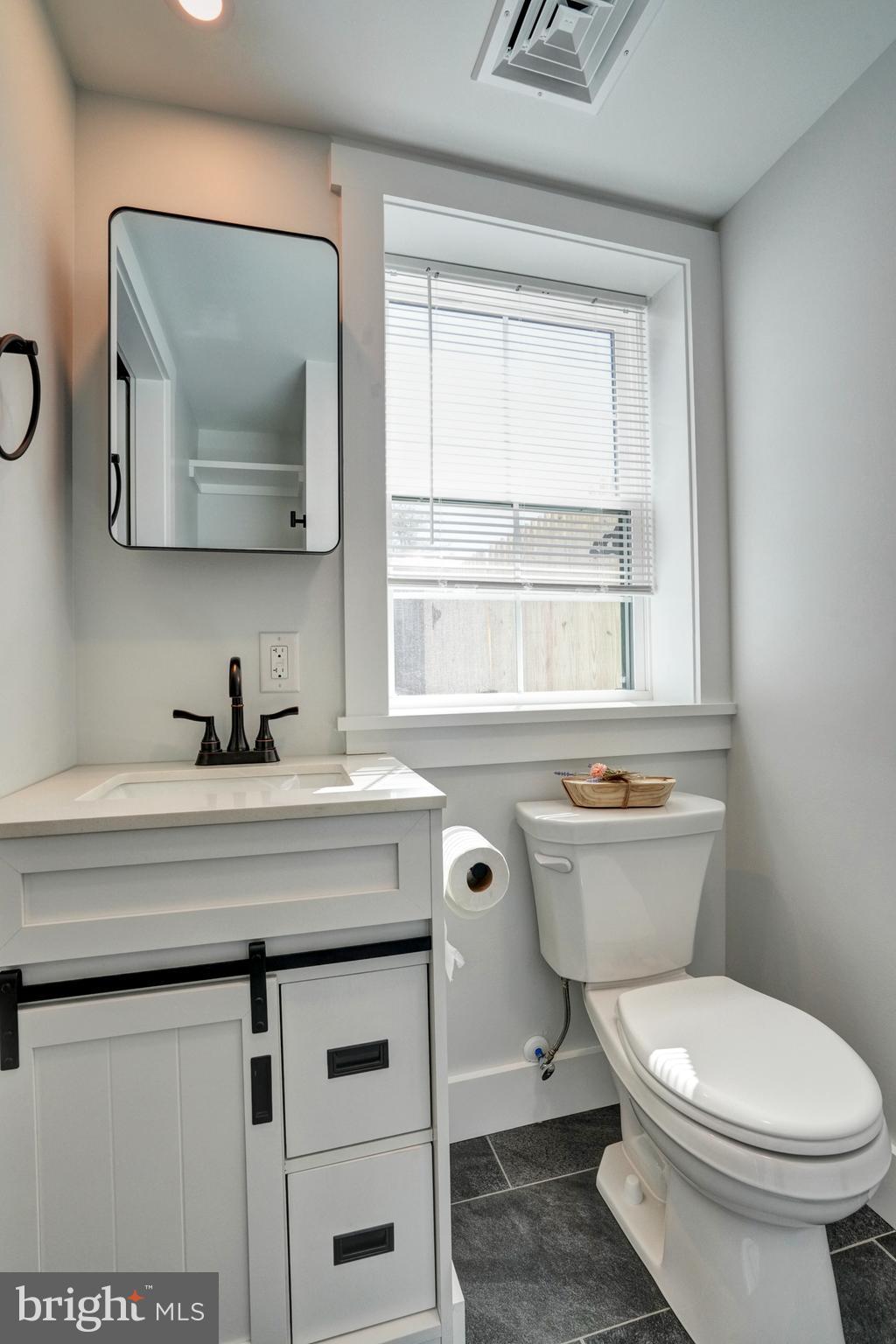 1312 Ship Road West Chester, PA 19380 - Photo 25 of 50 a bathroom with a toilet a sink and a window