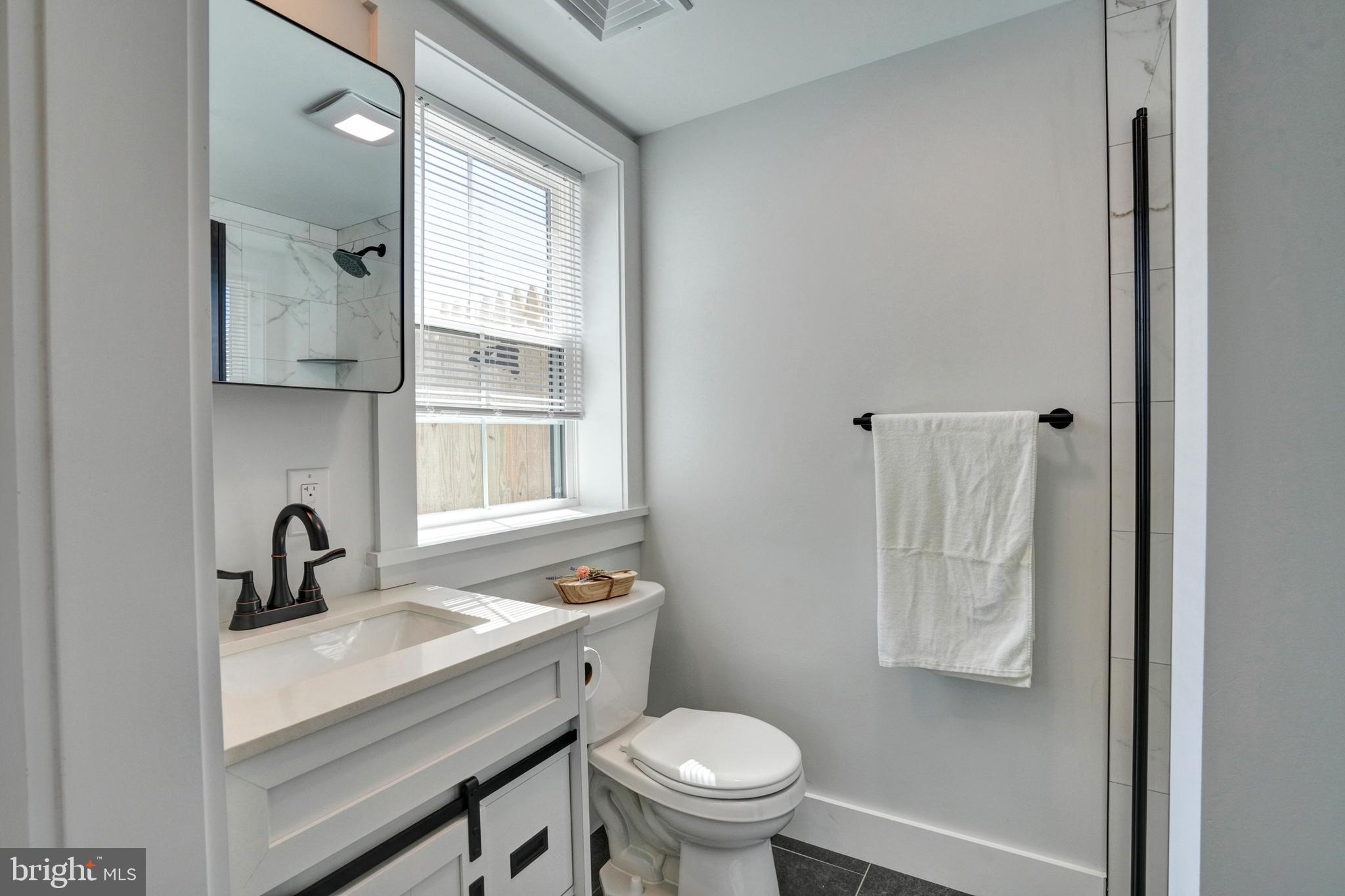 1312 Ship Road West Chester, PA 19380 - Photo 27 of 50 a bathroom with a sink toilet a mirror and vanity