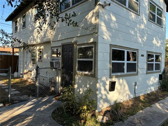 a front view of a building with a garden