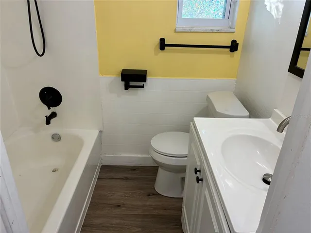 a bathroom with a toilet sink and shower