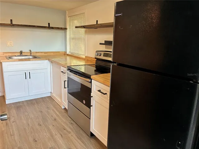 a kitchen with a sink and a refrigerator