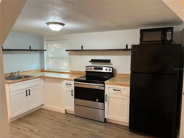 a kitchen with a stove and a refrigerator