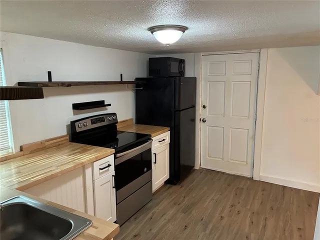 a kitchen with a stove and a refrigerator