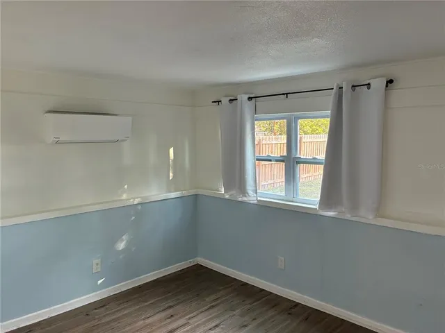 a room with a window and wooden floor