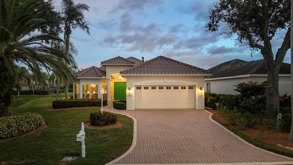 a front view of house with yard and green space