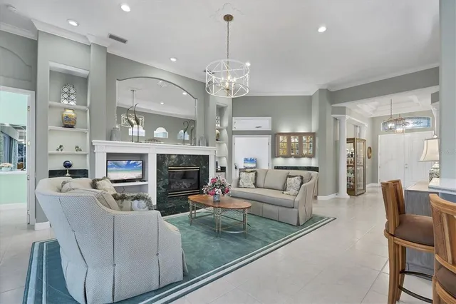 a living room with furniture a chandelier and a dining table