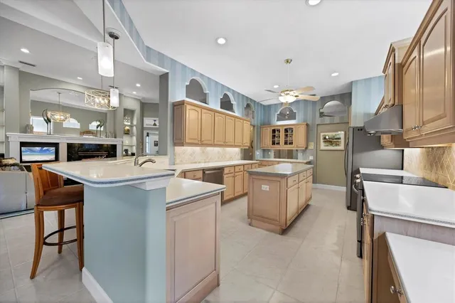 a dining room with furniture a chandelier and wooden floor