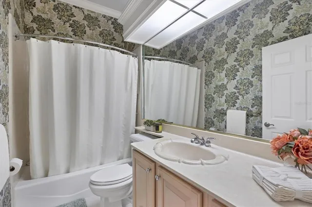 a bedroom with a bed and a flat tv screen on the dresser