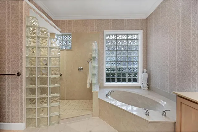 a spacious bedroom with a large bed and a chandelier