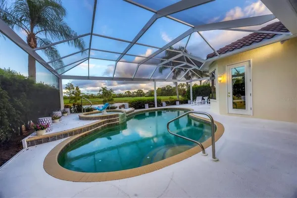 a kitchen with stainless steel appliances granite countertop a sink and a refrigerator