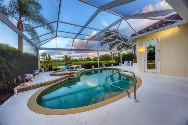 a kitchen with stainless steel appliances granite countertop a sink and a refrigerator