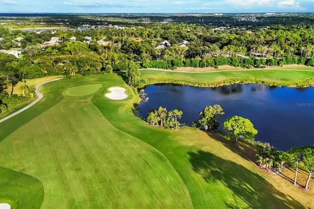 an aerial view of a house with a swimming pool yard and outdoor seating
